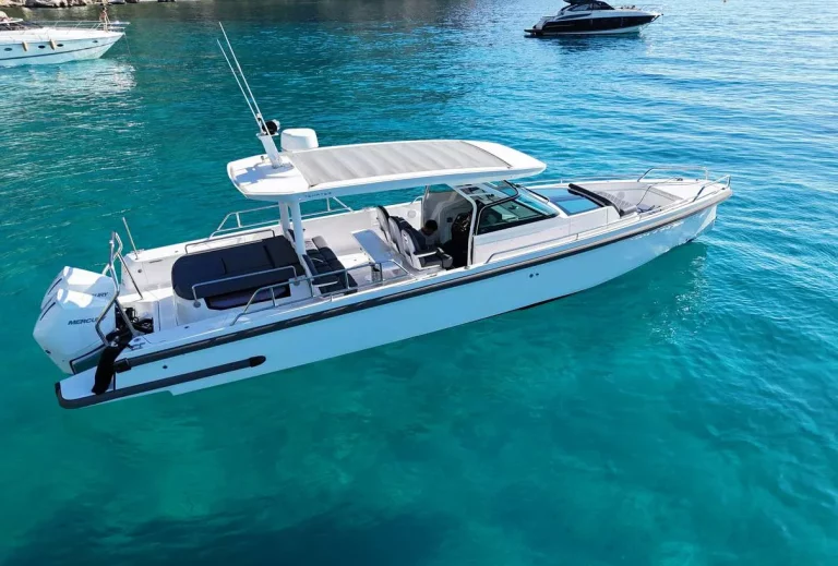 Axopar 37 Sun Top 2020 — port quarter view over turquoise water