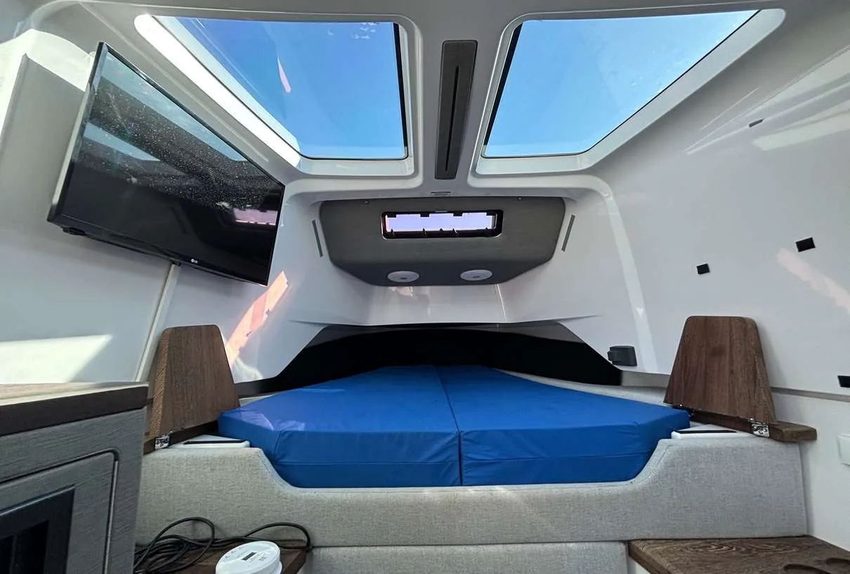 Axopar 37 Sun Top 2020 — forward cabin with double berth and TV