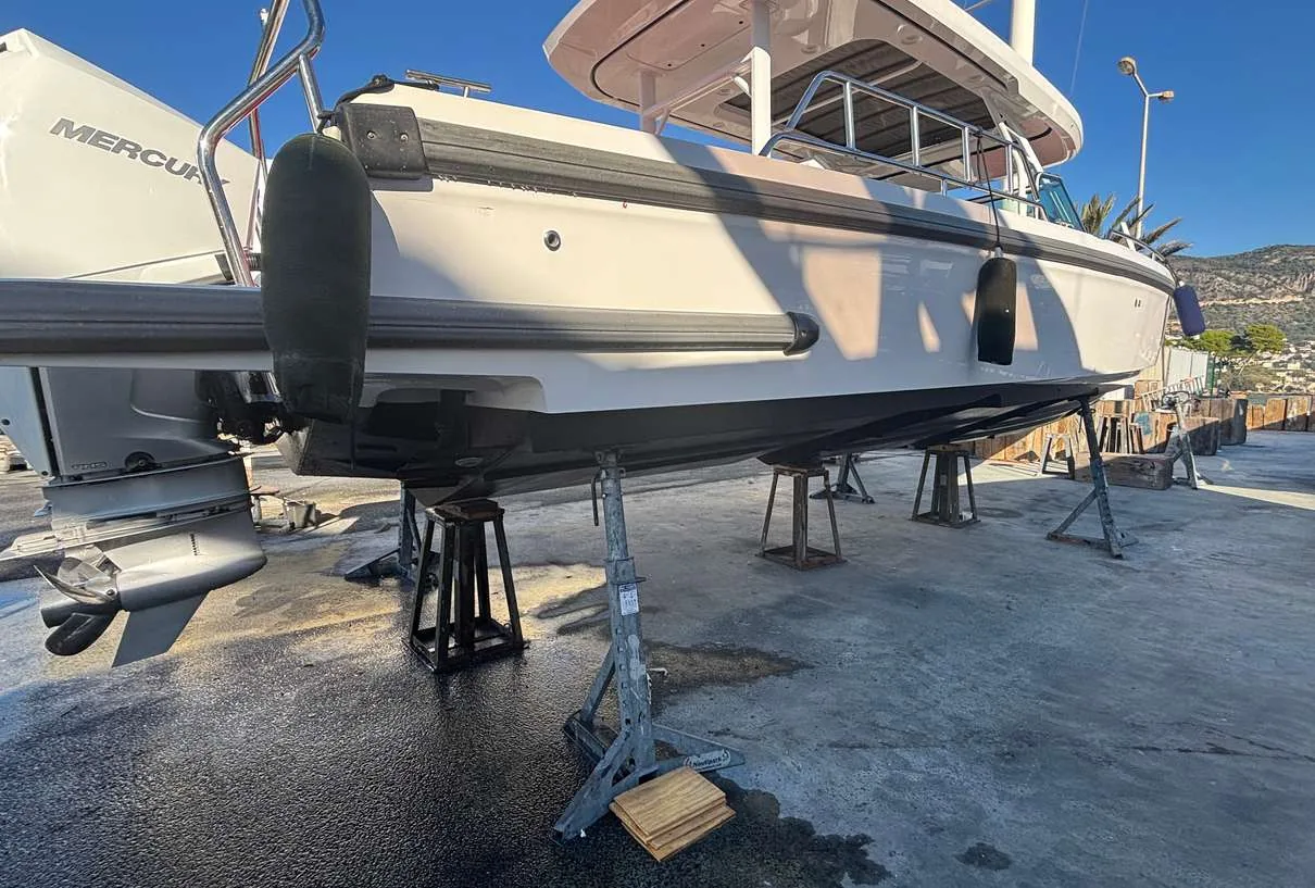 Axopar 37 Sun Top 2020 — hull and outboards ashore during service
